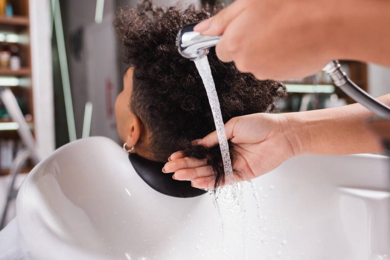 stock-photo-african-american-hairdresser-washing-hair-client-sink